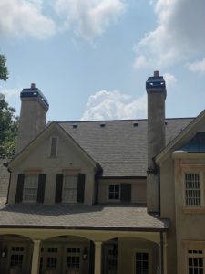 a large house with two chimneys on the roof .