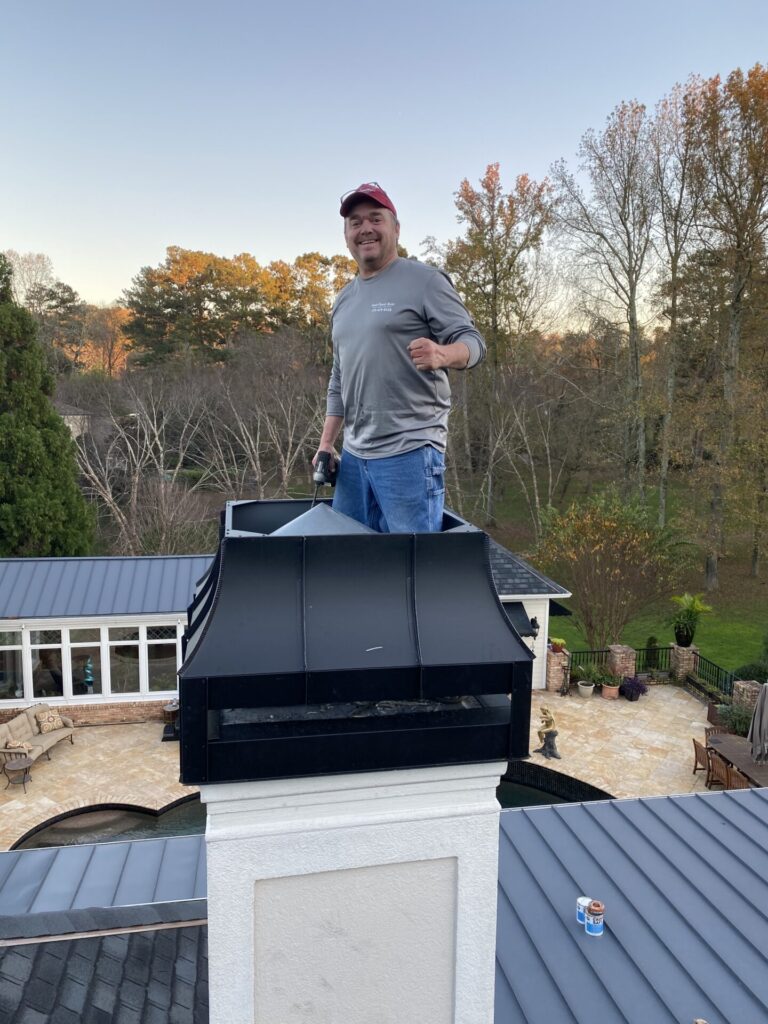 man working on inspection of chimney for a home
